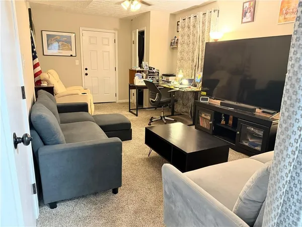 a living room with furniture and large window