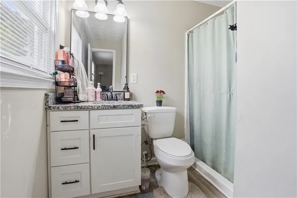 a bathroom with a toilet a sink and a mirror