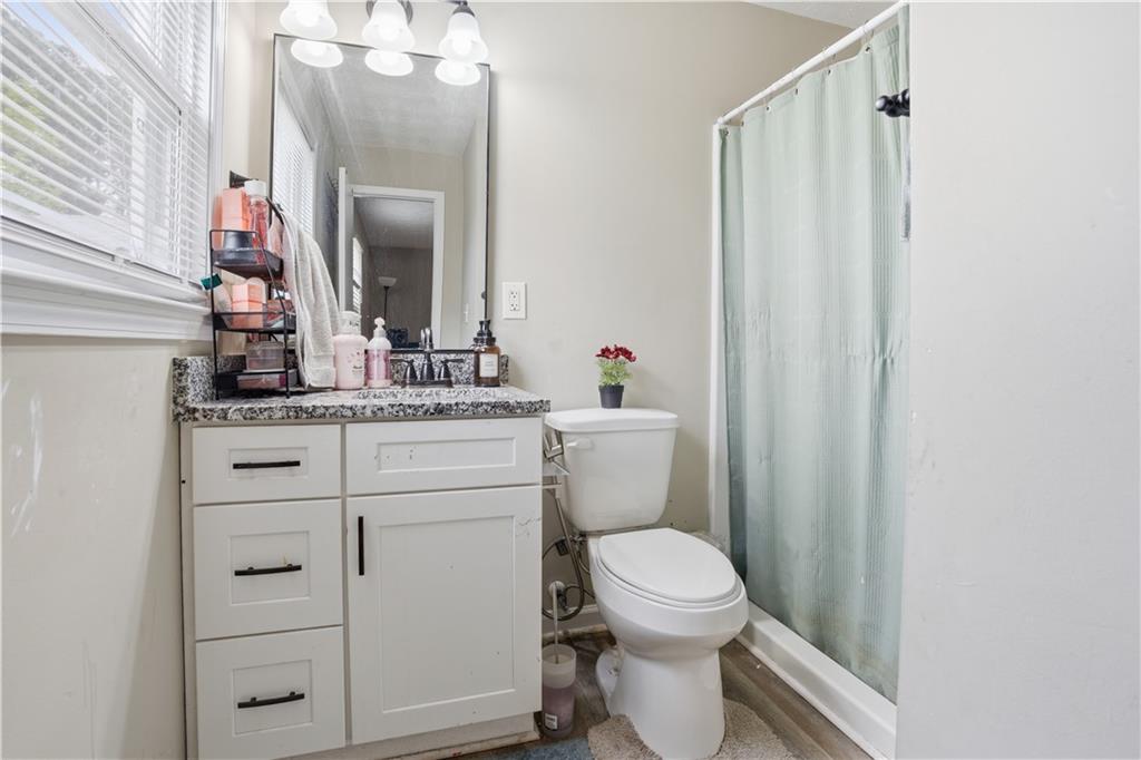 3002 Jennings Court Powder Springs, GA 30127 - Photo 19 of 47 a bathroom with a toilet a sink and a mirror