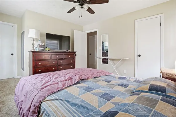 a bedroom with a bed and a television