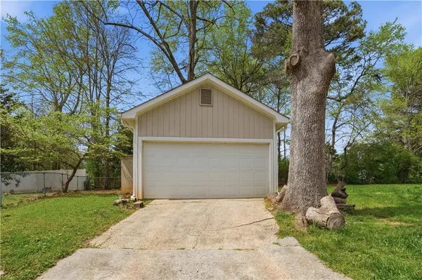 a small yard with a large tree and a yard