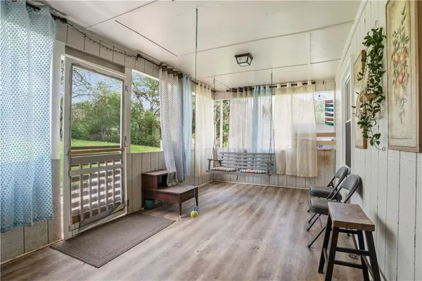 a view of a room with furniture wooden floor and windows