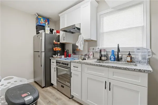 a kitchen with sink cabinets and window