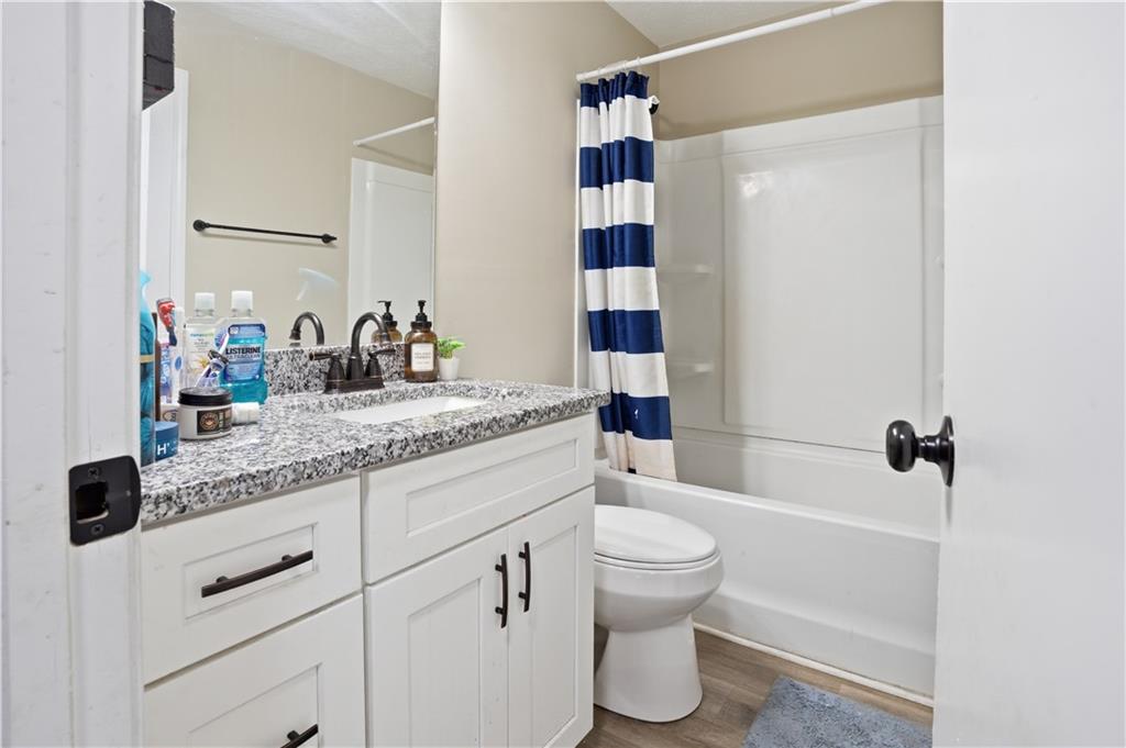 3002 Jennings Court Powder Springs, GA 30127 - Photo 36 of 47 a bathroom with a granite countertop sink toilet and shower