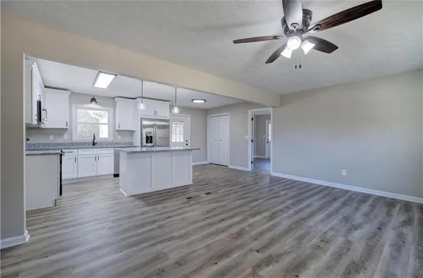 a view of kitchen with granite countertop cabinets and stainless steel appliances