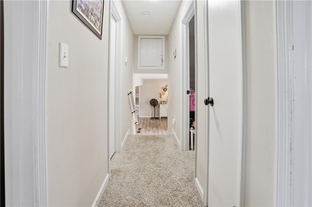 3002 Jennings Court Powder Springs, GA 30127 - Photo 46 of 47 a view of a hallway with white walls and stairs