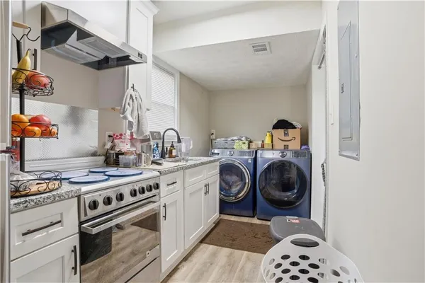 a kitchen with a stove a sink and cabinets