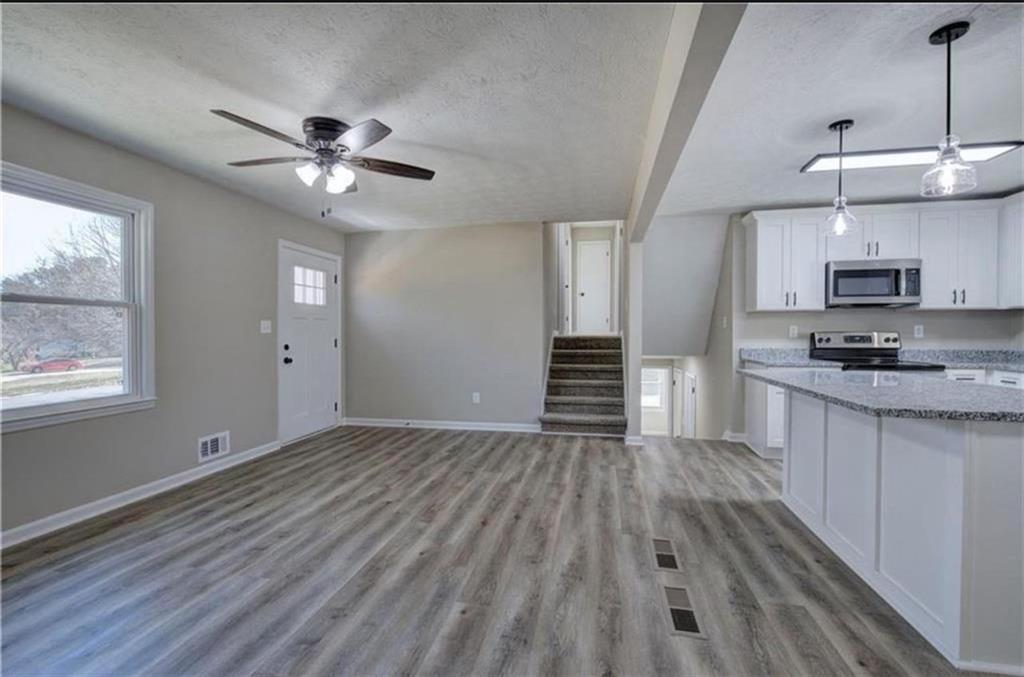 3002 Jennings Court Powder Springs, GA 30127 - Photo 5 of 47 a view of kitchen and empty room with wooden floor