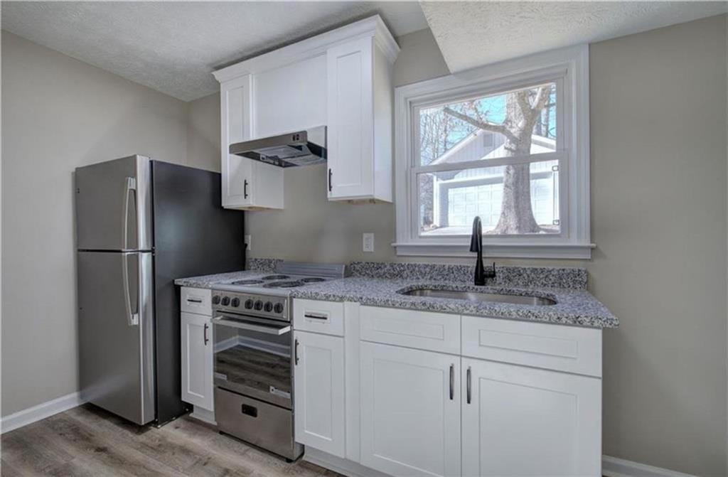 3002 Jennings Court Powder Springs, GA 30127 - Photo 8 of 47 a kitchen with a refrigerator and a sink