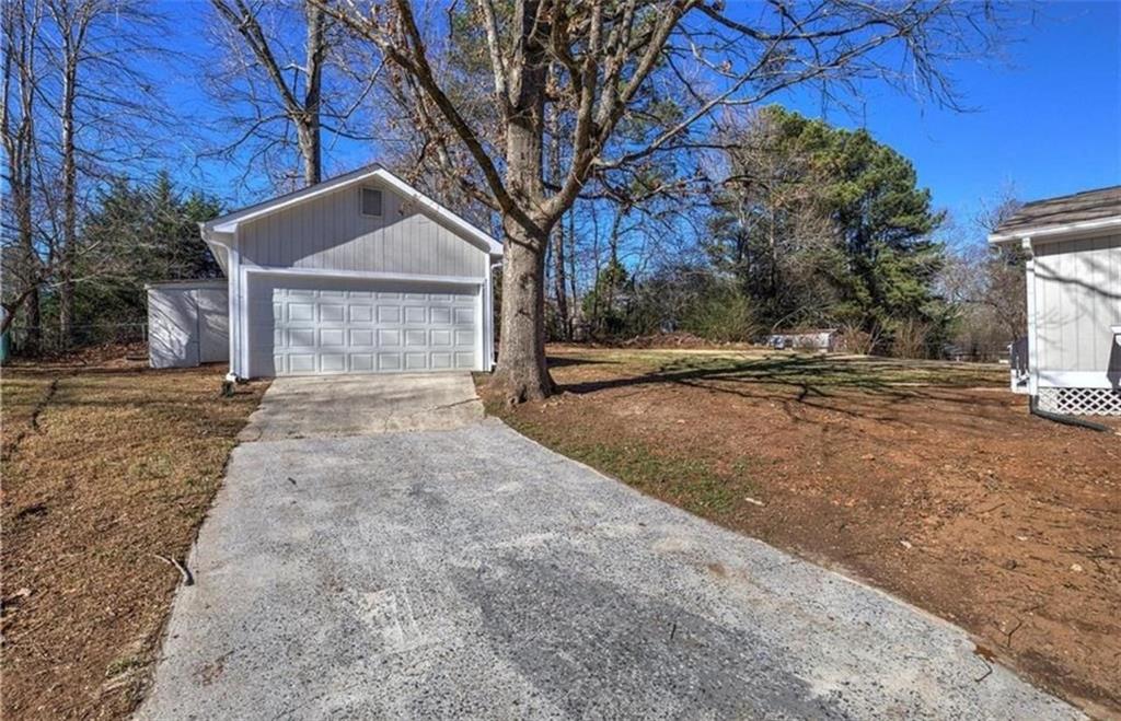 3002 Jennings Court Powder Springs, GA 30127 - Photo 10 of 47 a front view of a house with a yard and garage