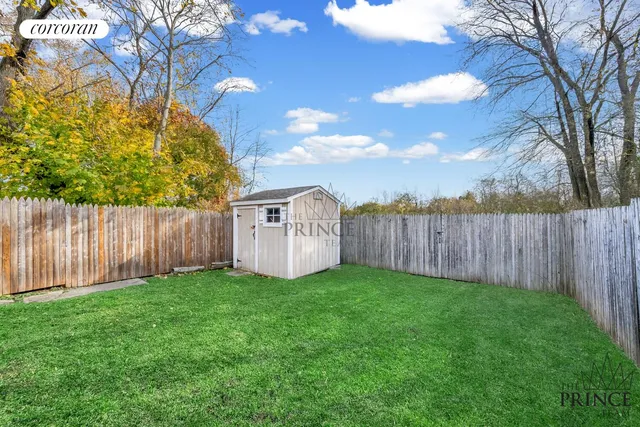 a view of a small yard with wooden fence
