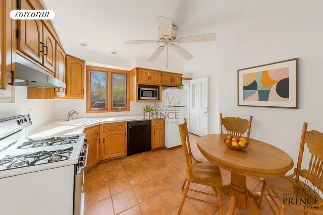 a kitchen with a table chairs stove and refrigerator