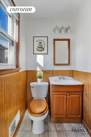 a bathroom with a toilet a sink and mirror