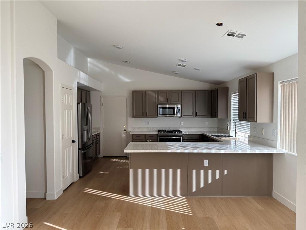 2122 Hidden Ranch Terrace Henderson, NV 89052 - Photo 8 of 20 A well-appointed kitchen features a practical layout, modern appliances, and light wood flooring.