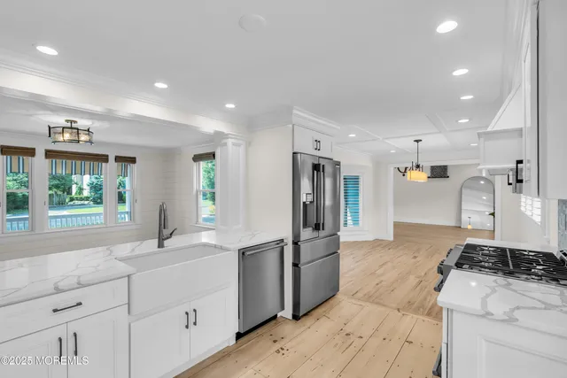 a kitchen with a stove and a white wooden cabinets