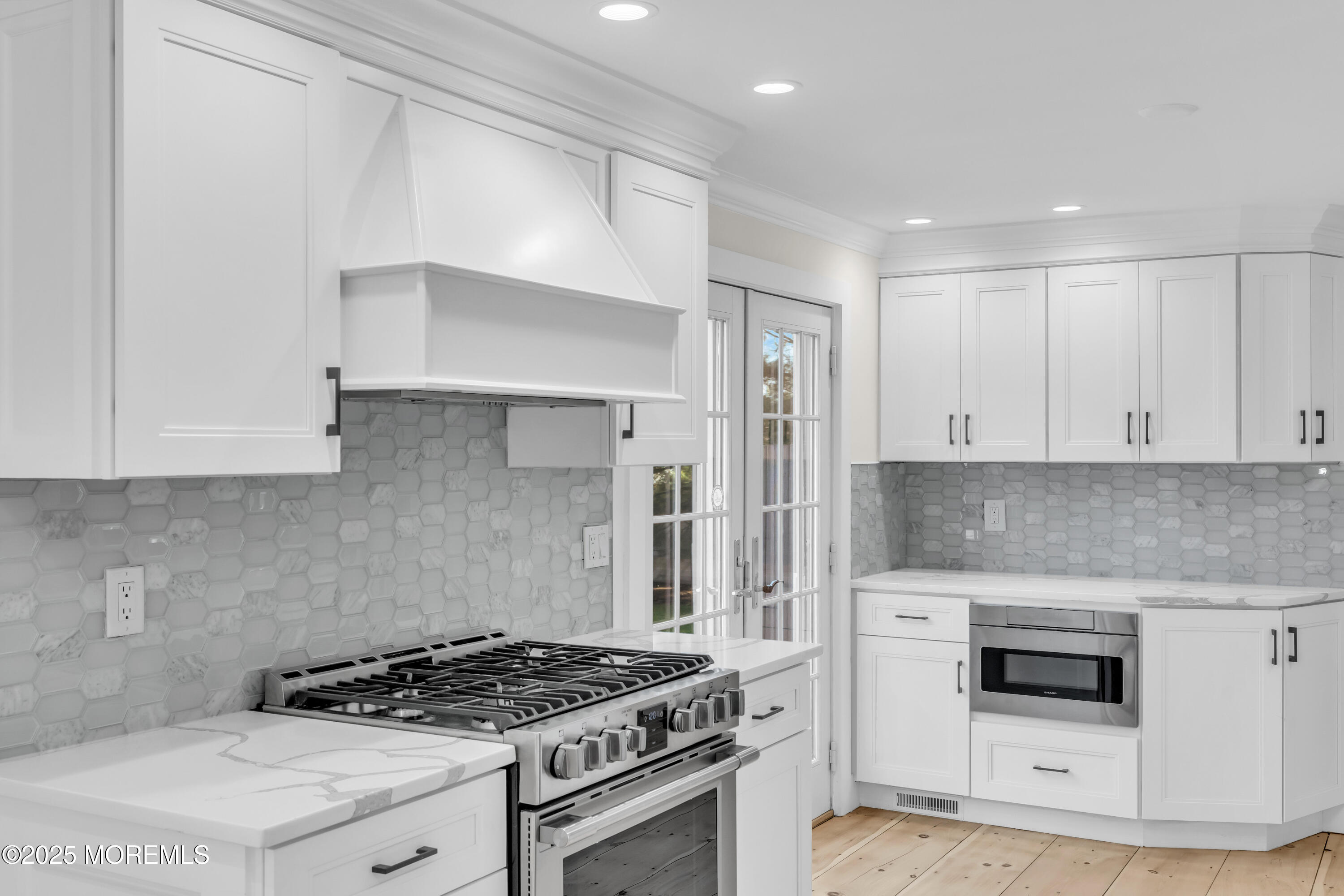 406 Brown Street Brielle, NJ 08730 - Photo 12 of 72 a kitchen with white cabinets and appliances