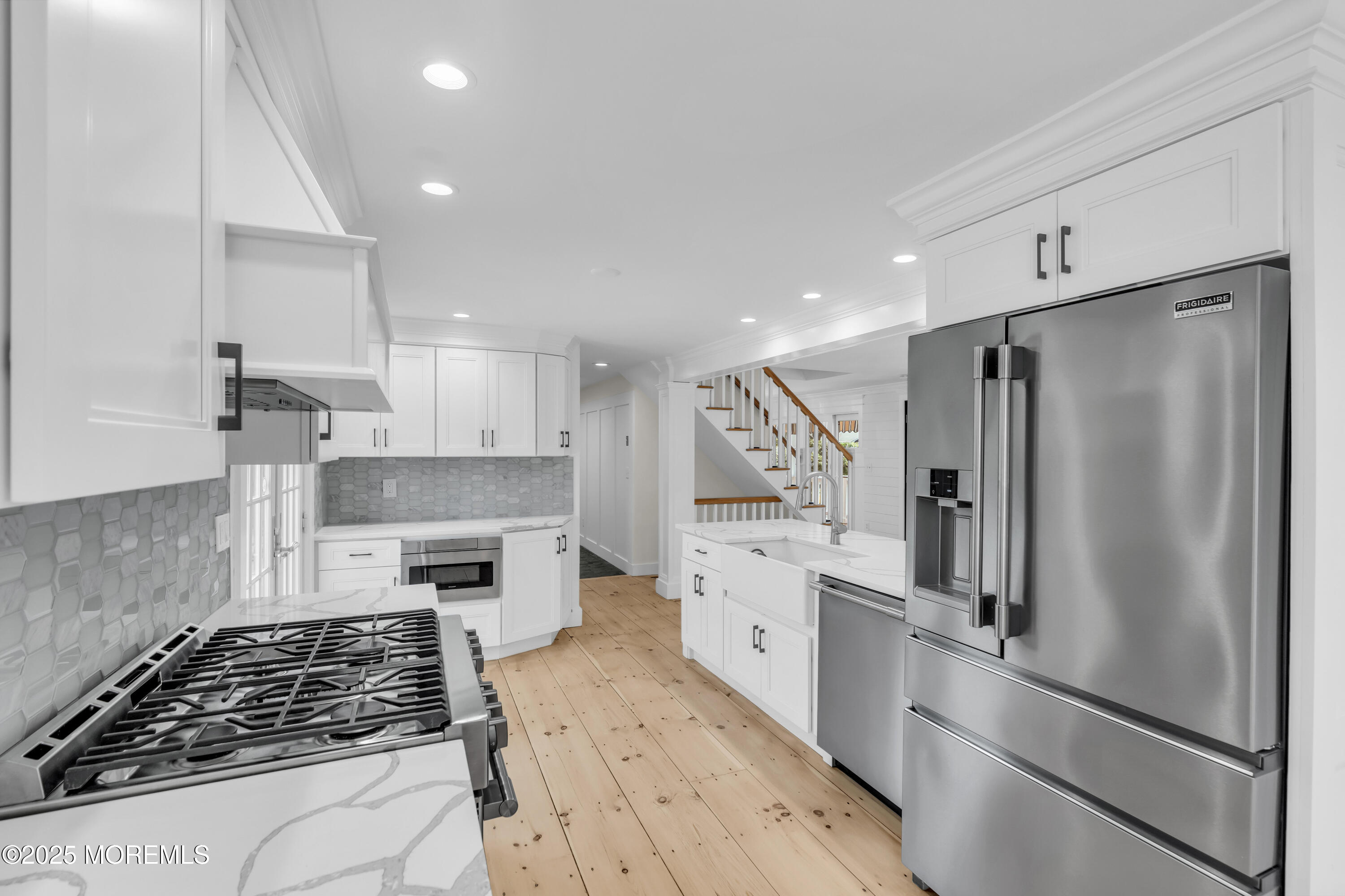 406 Brown Street Brielle, NJ 08730 - Photo 15 of 72 a kitchen with white cabinets and stainless steel appliances