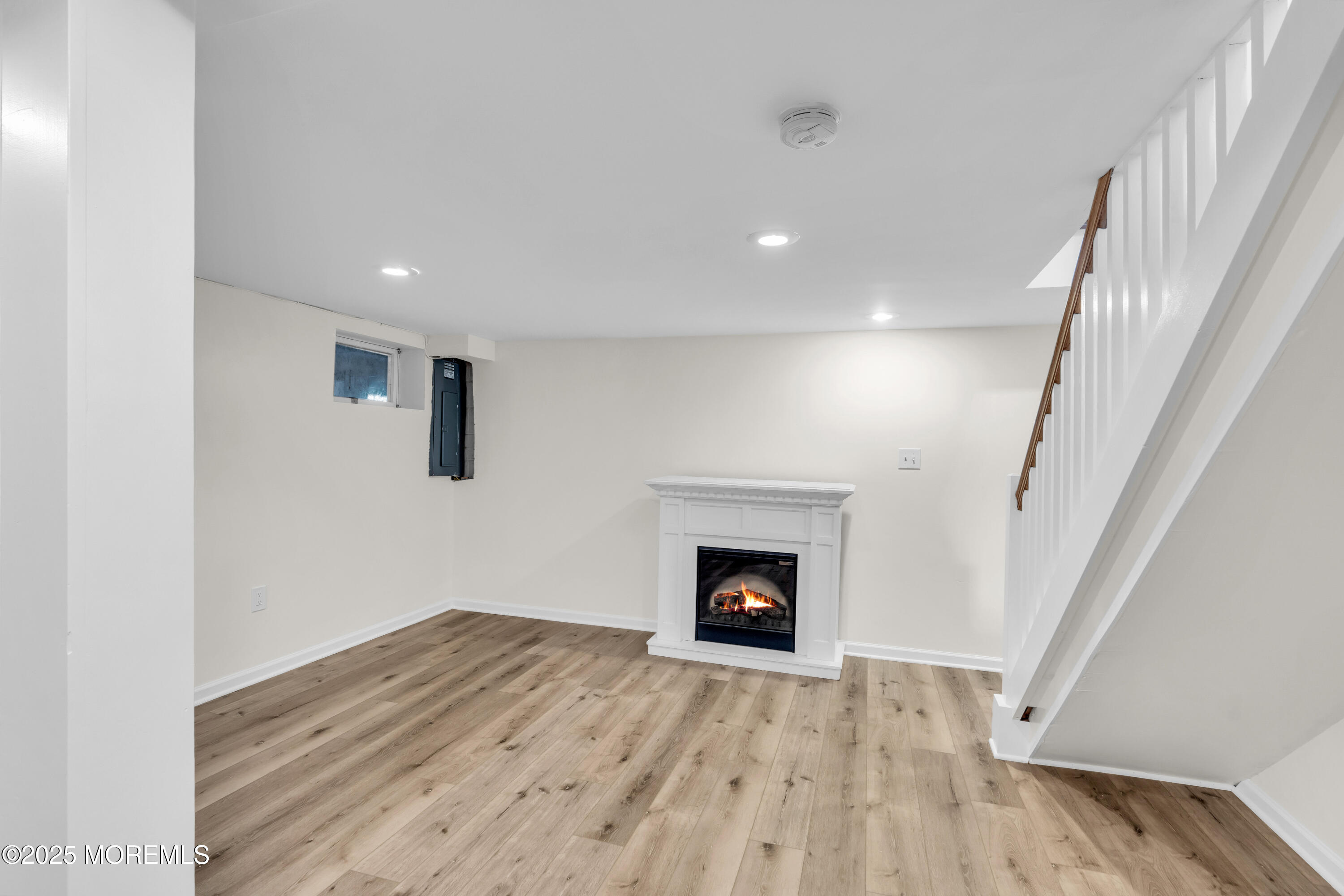 406 Brown Street Brielle, NJ 08730 - Photo 43 of 72 a view of an empty room with wooden floor fireplace and a window
