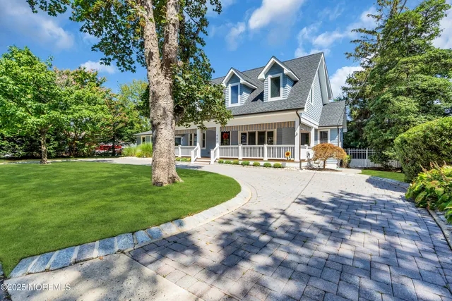 a front view of a house with a yard table and chairs