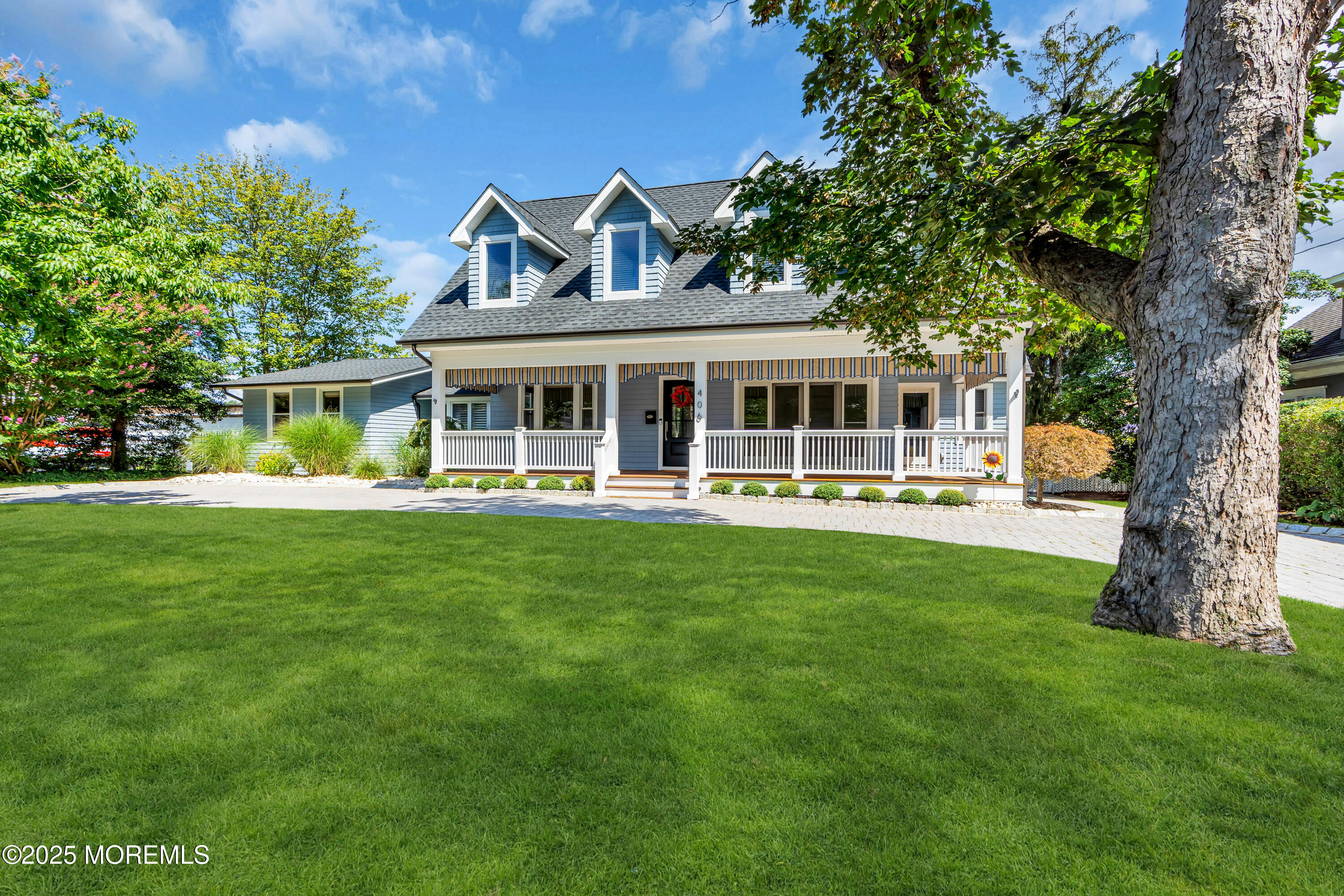 406 Brown Street Brielle, NJ 08730 - Photo 6 of 72 a front view of a house with a yard table and chairs