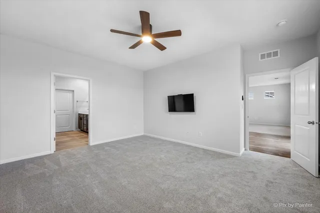 a view of a livingroom with a ceiling fan and window