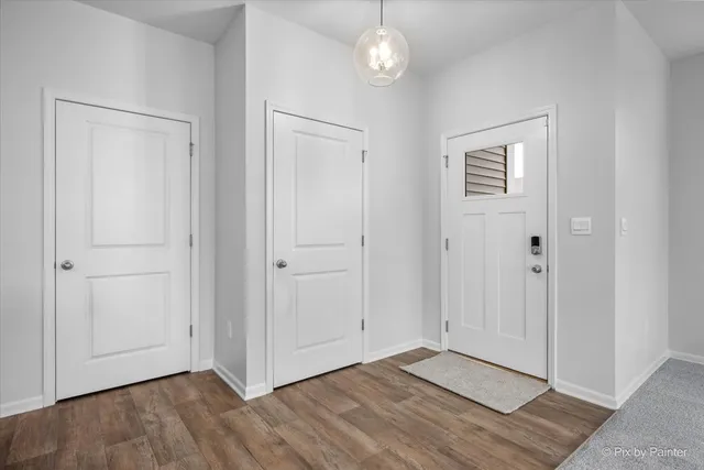 a view of an empty room and wooden floor