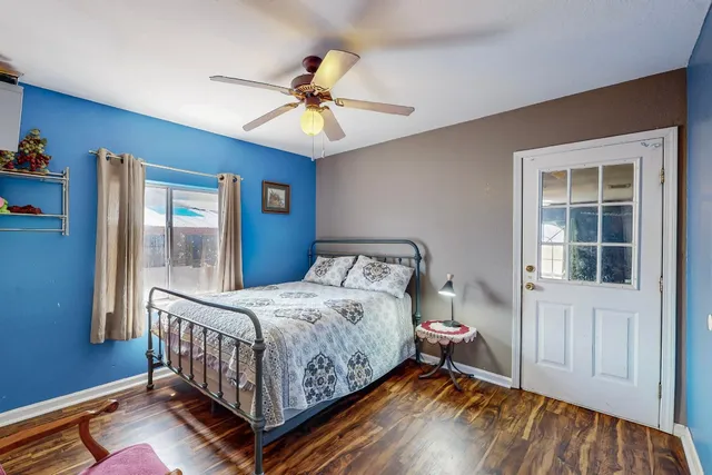 a bedroom with a bed and wooden floor