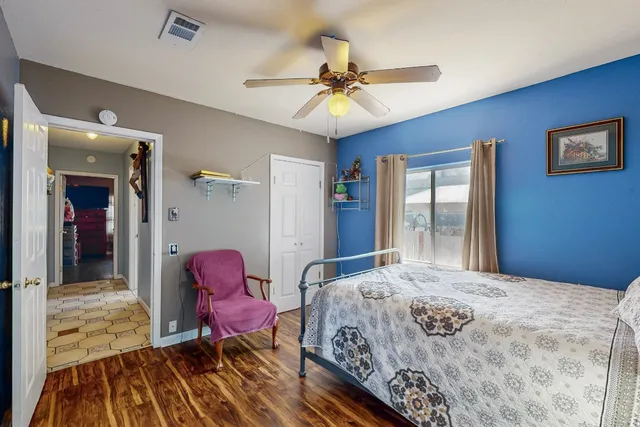 a bedroom with a bed and wooden floor