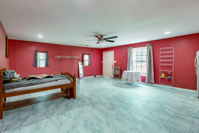 a bedroom with furniture and a ceiling fan