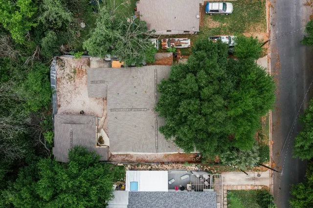 an aerial view of a house with outdoor space and street view