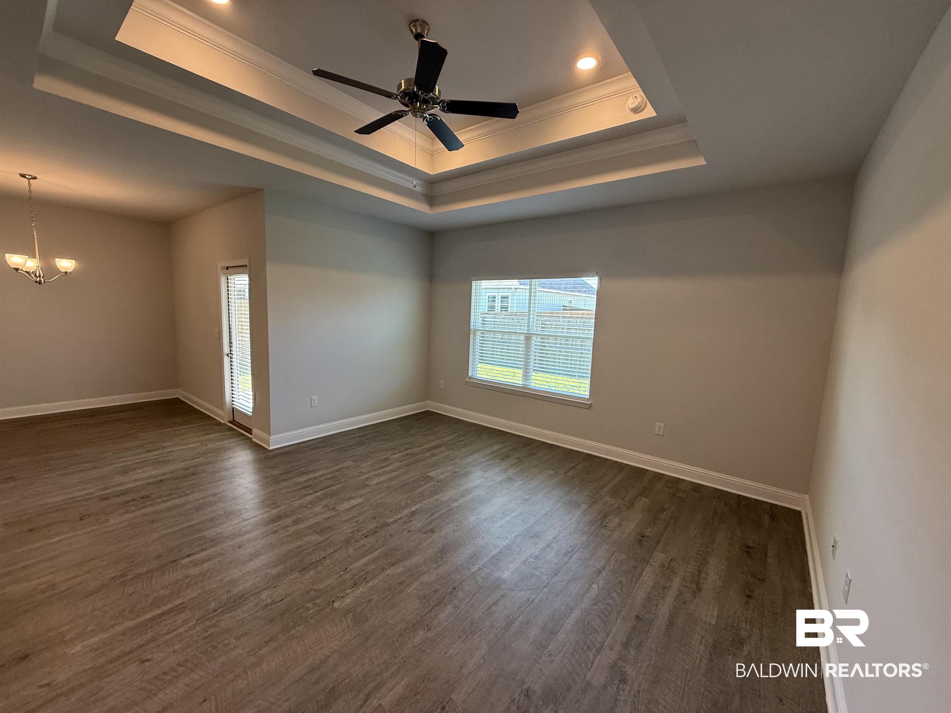 23247 Lieutenant Avenue Foley, AL 36535 - Photo 27 of 47 Spacious room featuring tray ceiling with recessed lighting and a ceiling fan