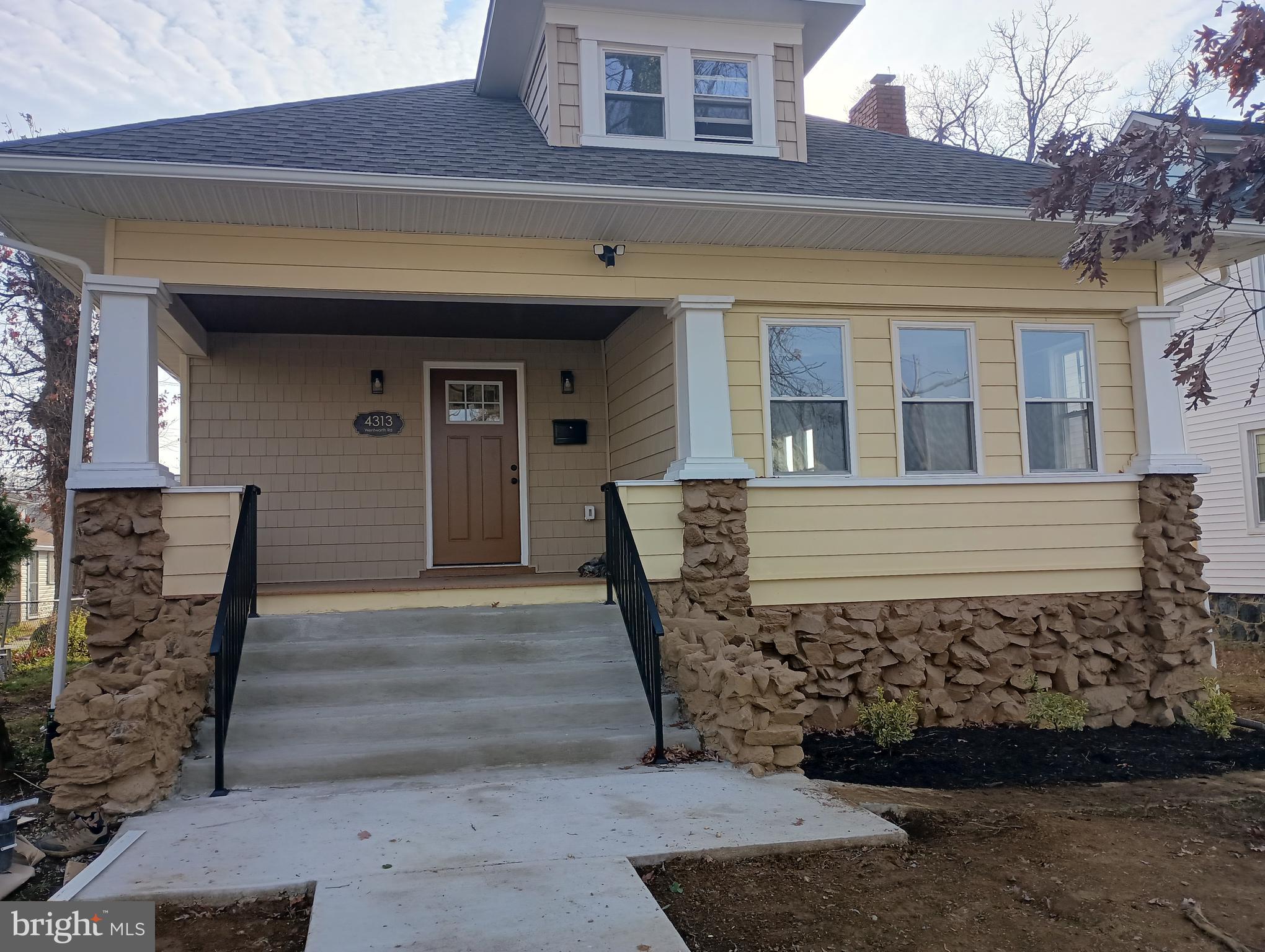 a view of a house with a wooden fence