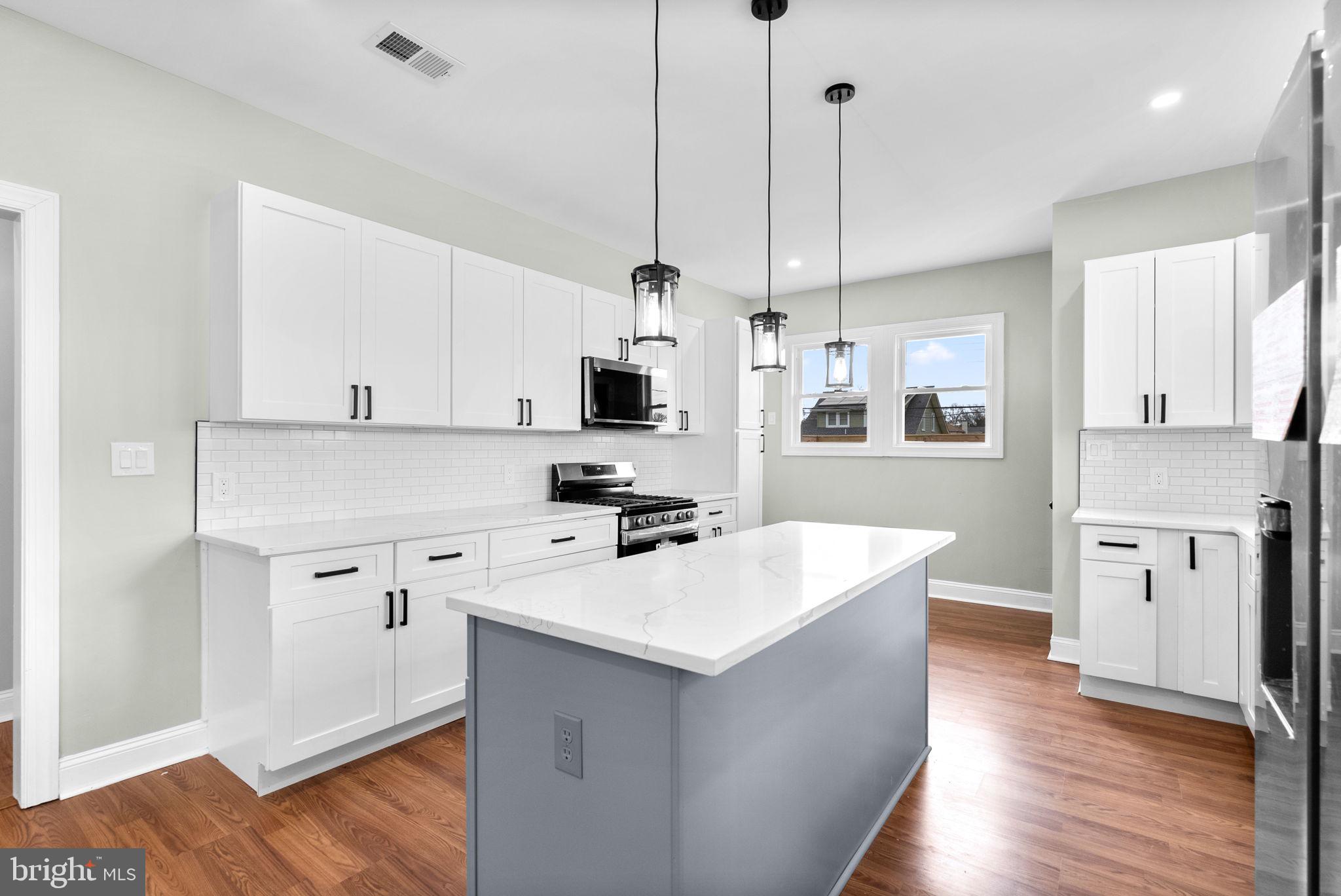 4313 Wentworth Road Baltimore, MD 21207 - Photo 15 of 46 a kitchen with white cabinets and white appliances