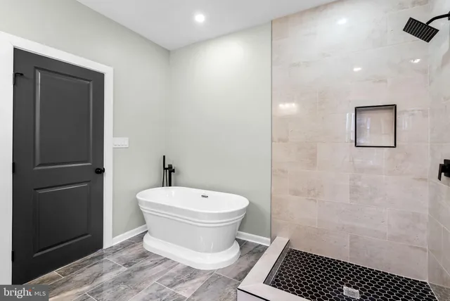 a bathroom with a bathtub and shower