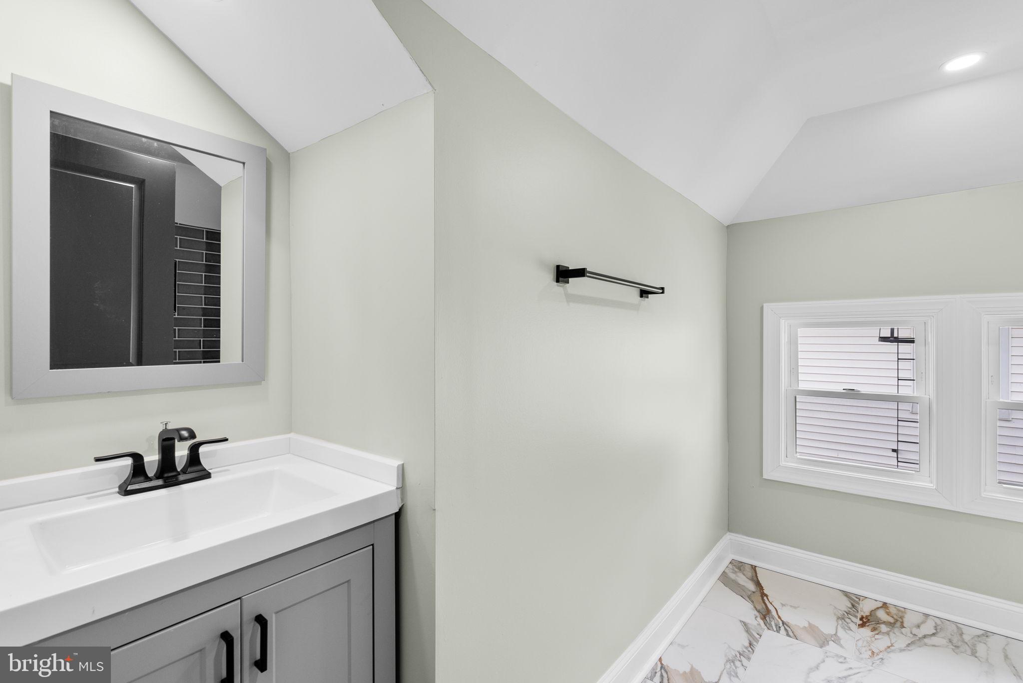 4313 Wentworth Road Baltimore, MD 21207 - Photo 30 of 46 a bathroom with a sink and a window