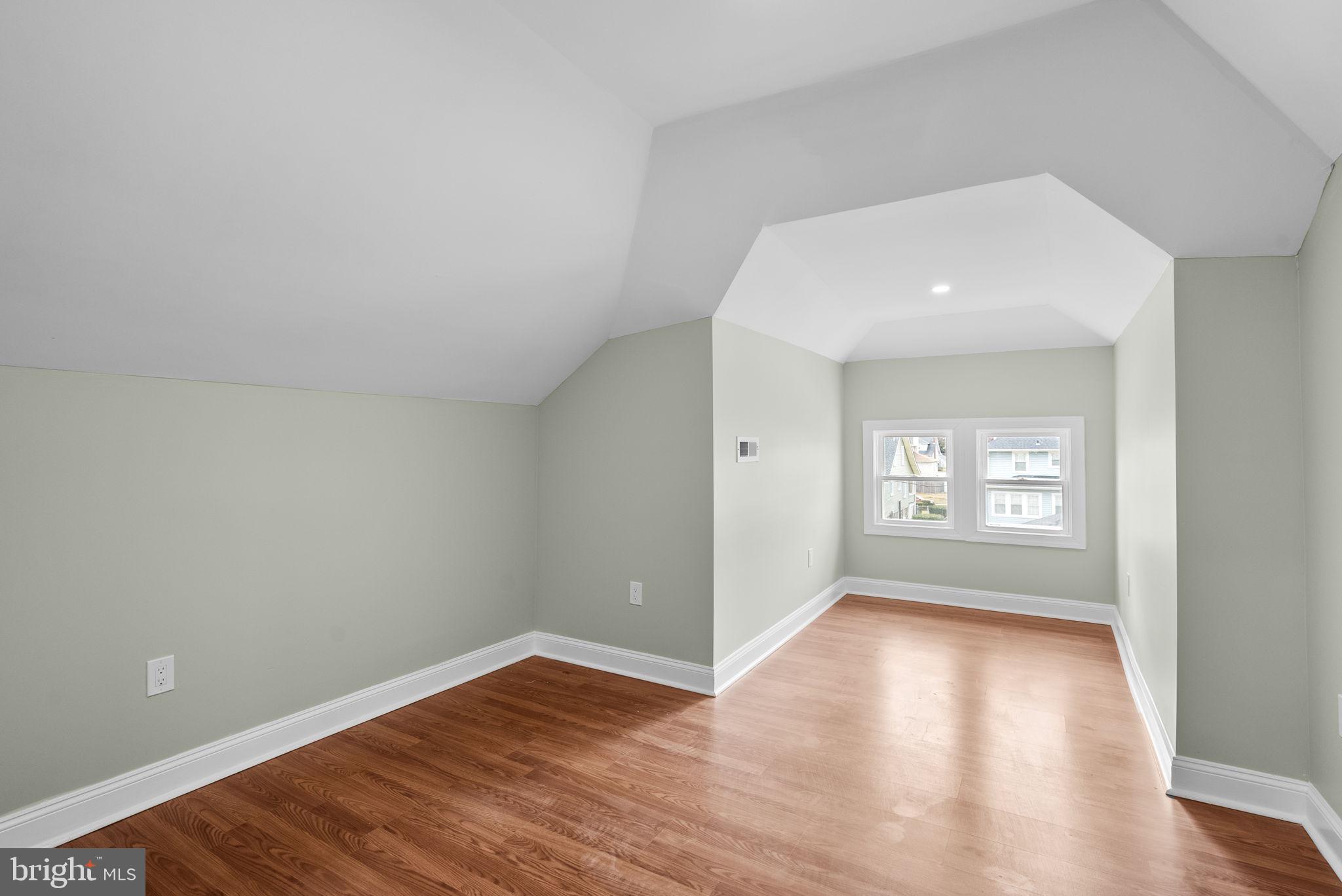 4313 Wentworth Road Baltimore, MD 21207 - Photo 31 of 46 a view of an empty room with wooden floor and a window