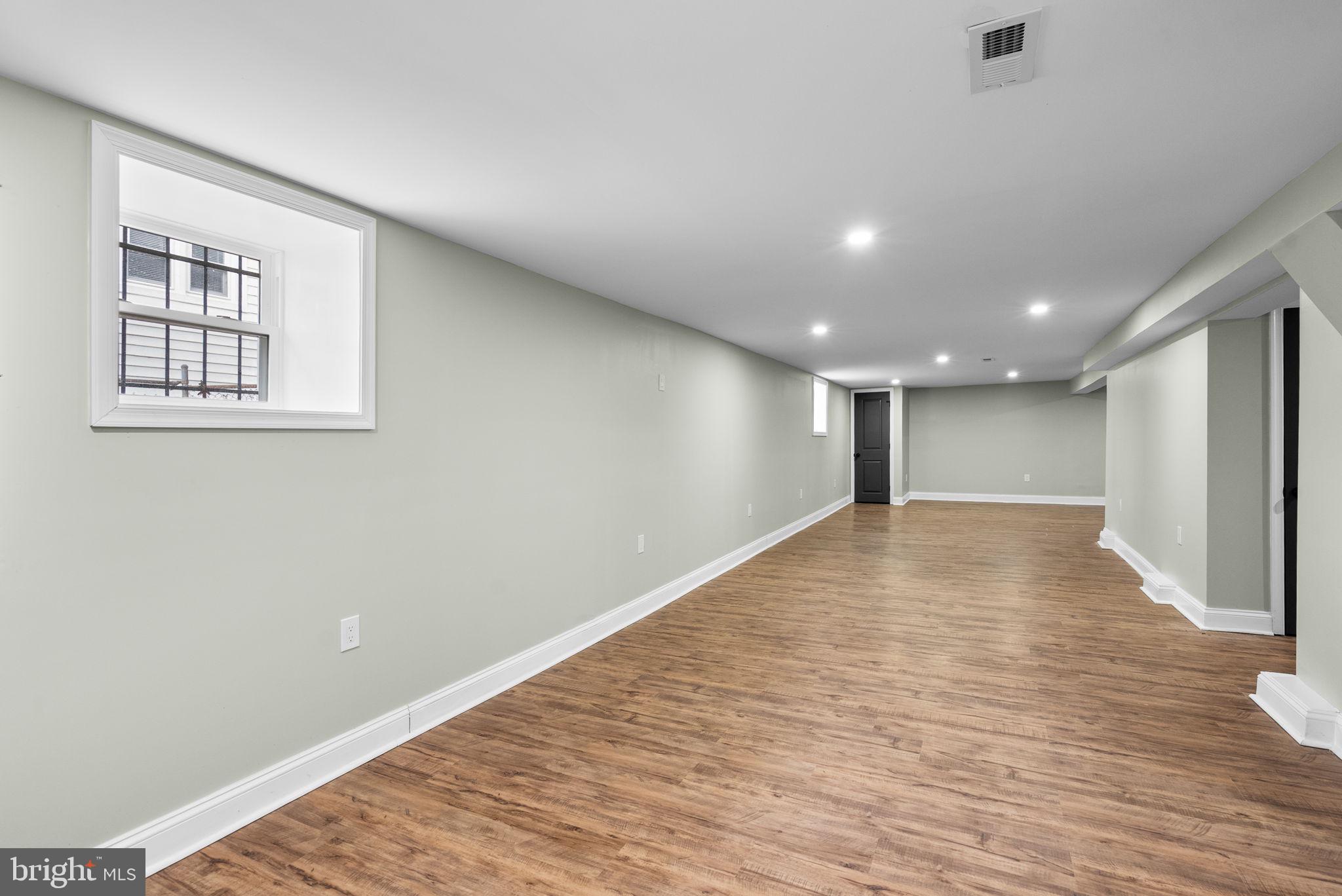 4313 Wentworth Road Baltimore, MD 21207 - Photo 40 of 46 a view of an empty room with wooden floor and a window