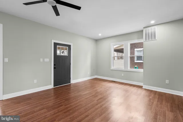 wooden floor in an empty room with a window