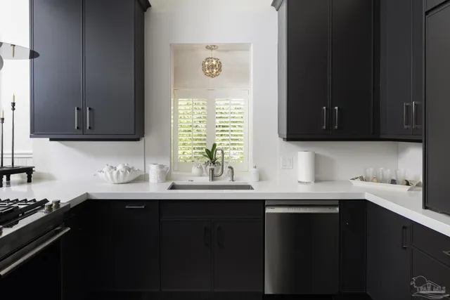 a kitchen with a sink a window and cabinets
