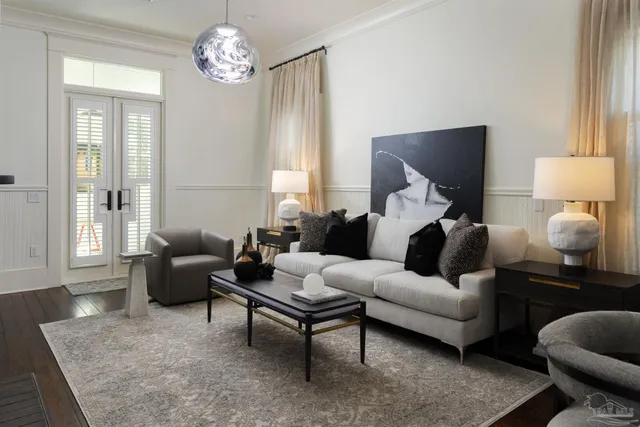 a living room with furniture chandelier and a window