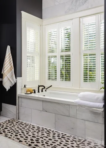 a bathroom with a bathtub and a window