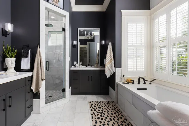 a large bathroom with a tub sink and mirror