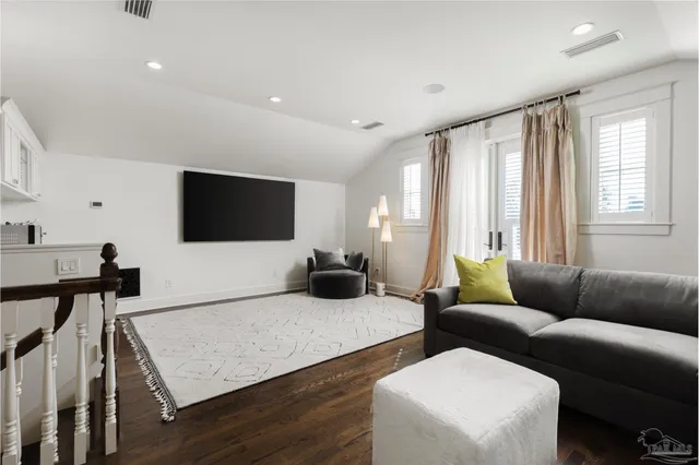 a living room with couches and a large window