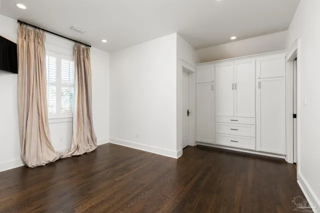 a spacious bathroom with a granite countertop sink and a mirror