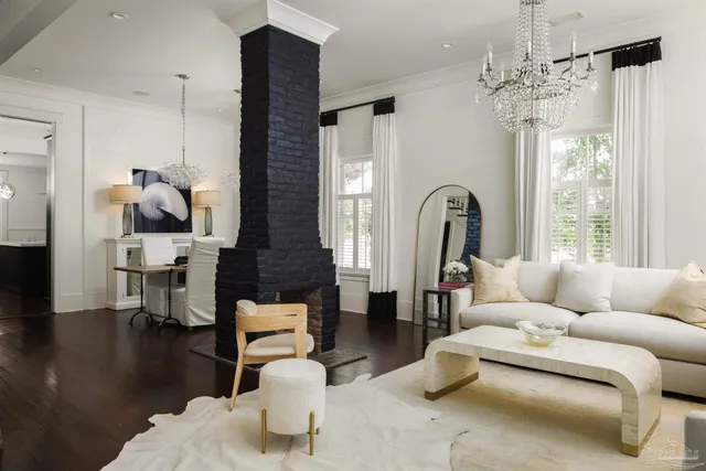 a living room with furniture and a chandelier