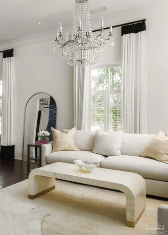 a living room with furniture and a chandelier