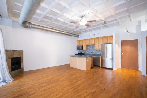 a kitchen with a refrigerator and a stove top oven