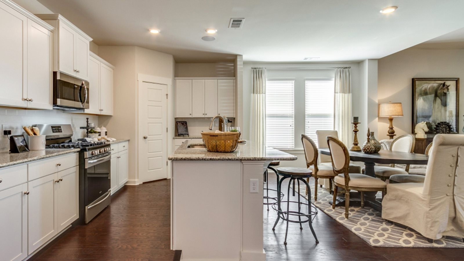 206 Goldfinch Rd Mount Mount Juliet, TN 37122 - Photo 5 of 15 a kitchen with stainless steel appliances kitchen island granite countertop a stove top oven a sink a dining table and chairs with wooden floor