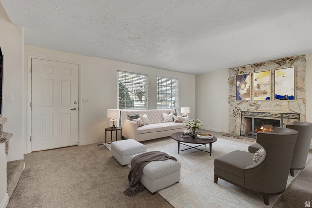 3166 Linden Street Bountiful, UT 84010 - Photo 2 of 25 Carpeted living room featuring a textured ceiling and a stone fireplace (virtually staged)