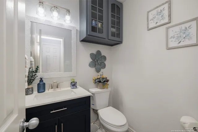 a bathroom with a toilet a sink and mirror